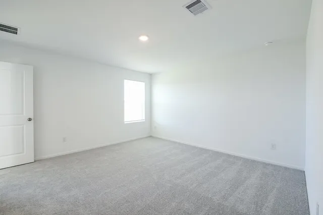 a view of an empty room and a window