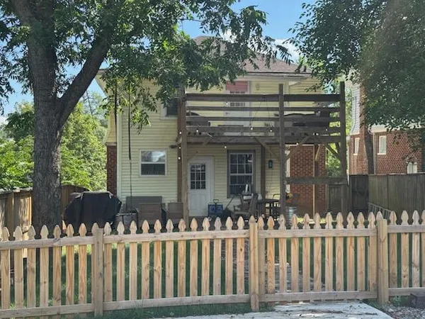 a view of a house with backyard porch and sitting area