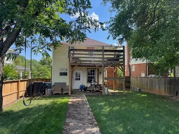 a view of a chair and table in backyard of the house