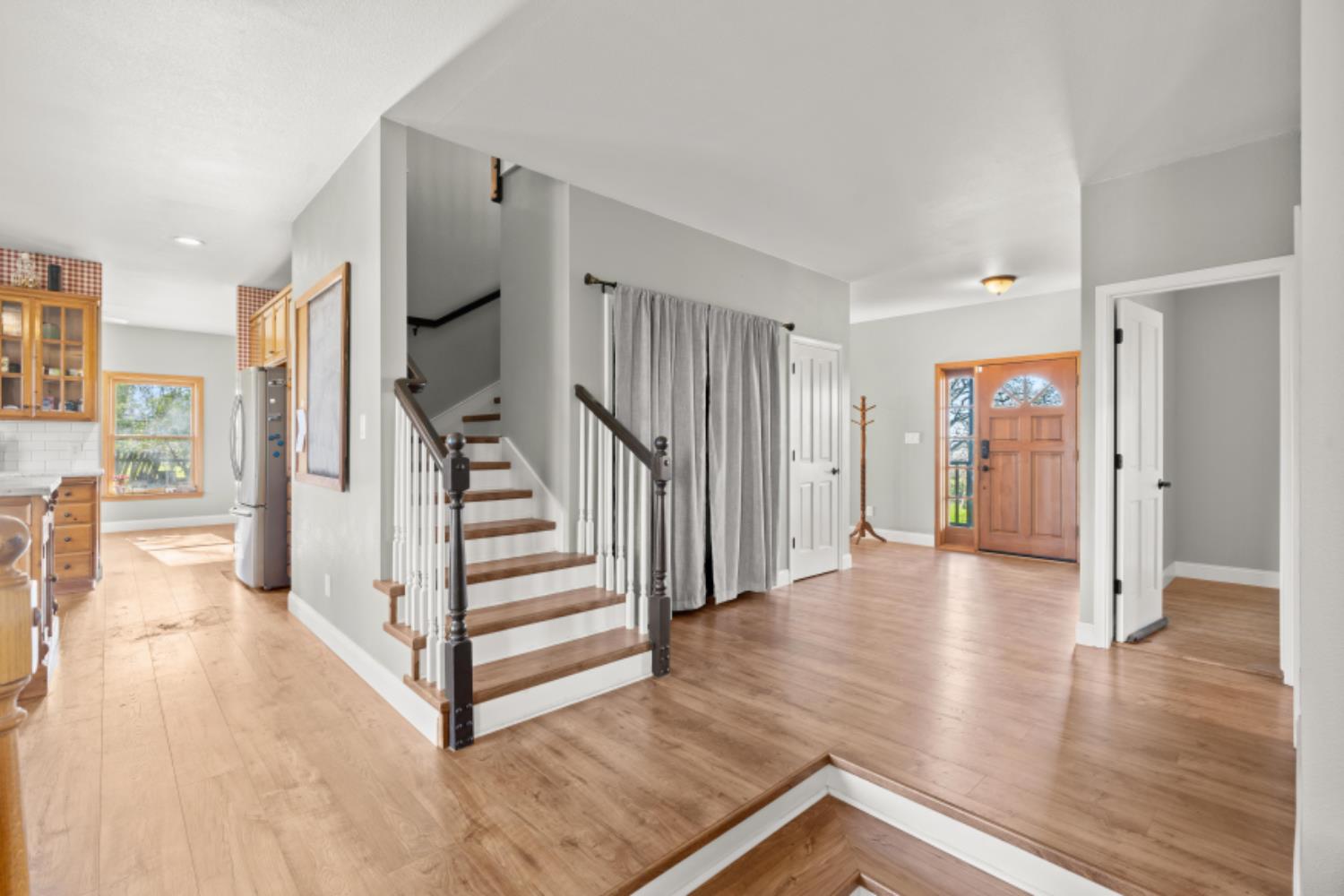 8251 Buffalo Ridge Road Ione, CA 95640 - Photo 17 of 75 a view of a hallway with wooden floor and staircase
