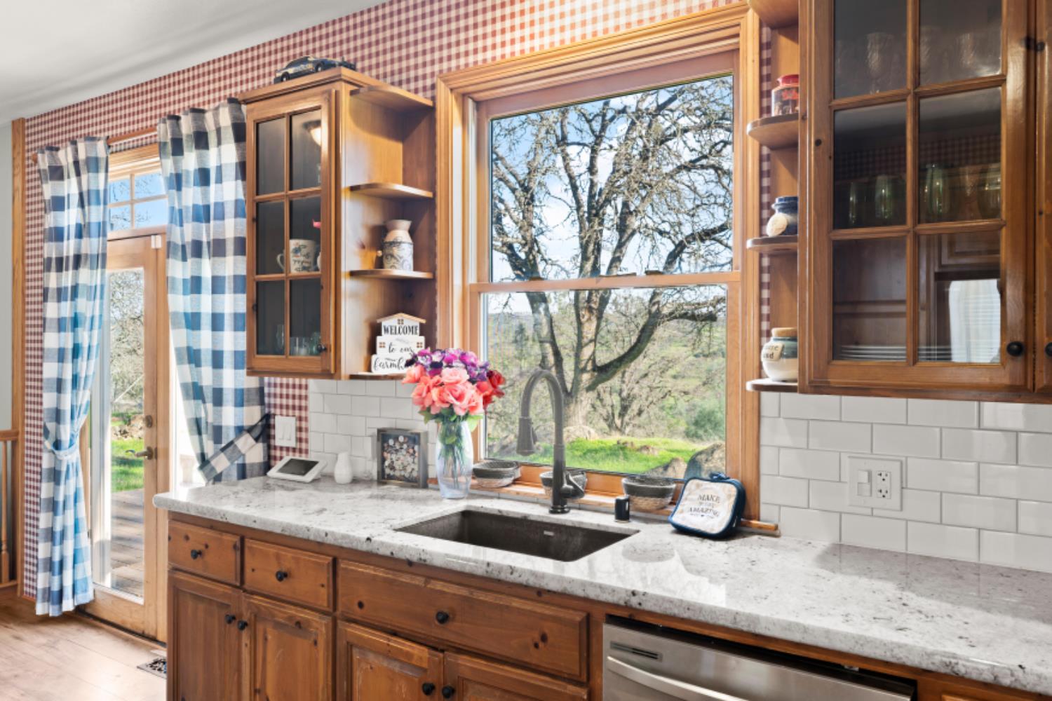 8251 Buffalo Ridge Road Ione, CA 95640 - Photo 25 of 75 a bathroom with a granite countertop sink and large window