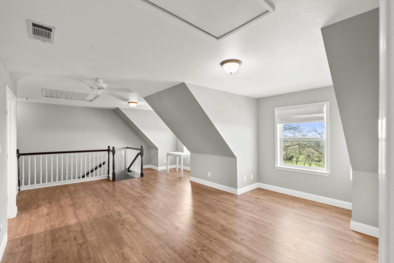 8251 Buffalo Ridge Road Ione, CA 95640 - Photo 35 of 75 a view of an empty room with wooden floor and a window