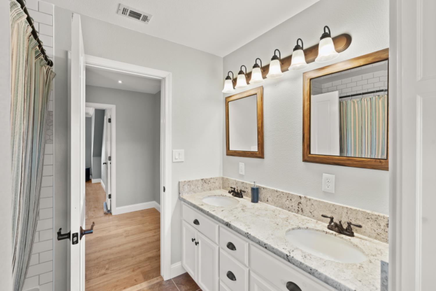 8251 Buffalo Ridge Road Ione, CA 95640 - Photo 45 of 75 a bathroom with a granite countertop sink mirror and