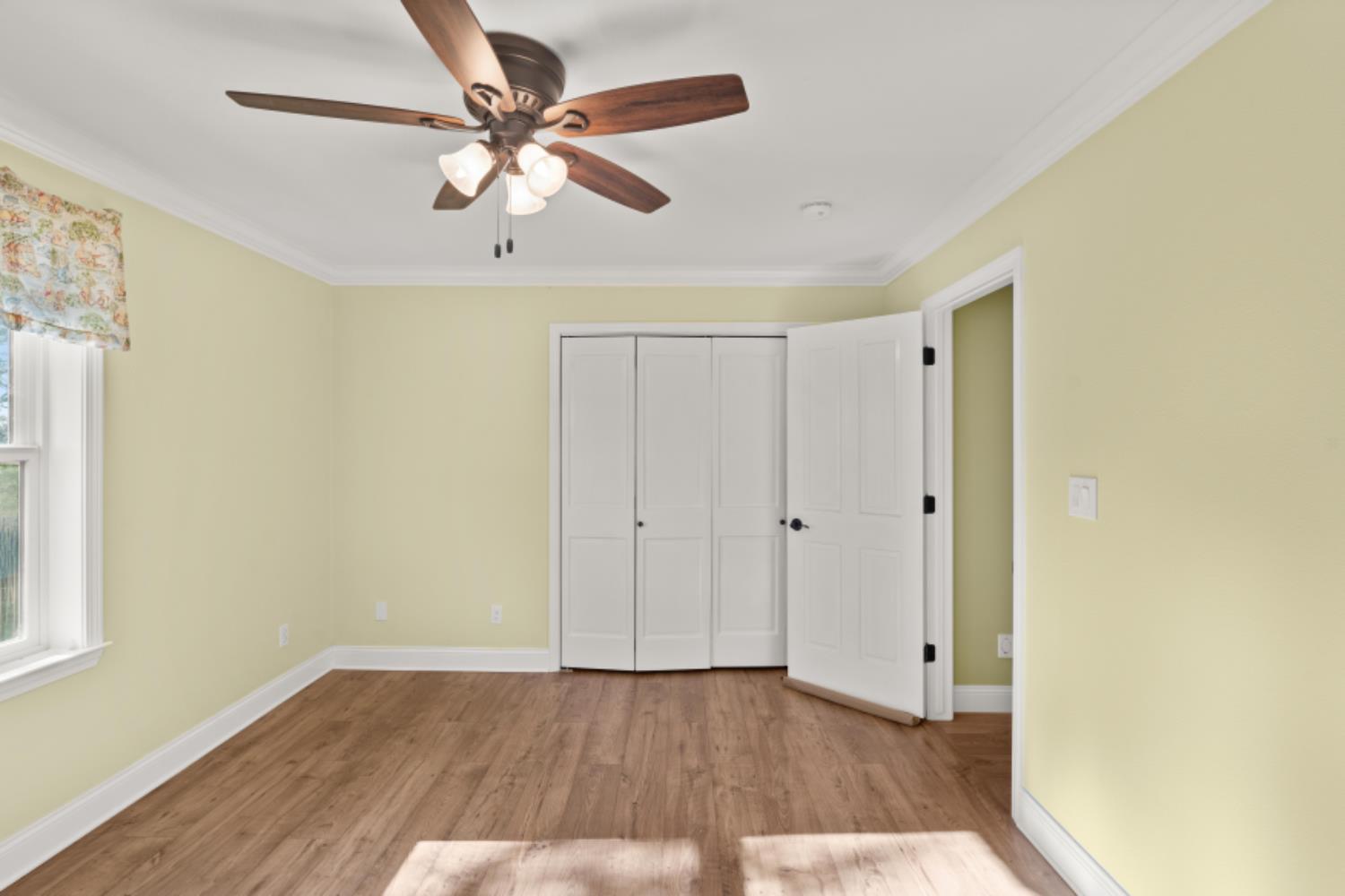 8251 Buffalo Ridge Road Ione, CA 95640 - Photo 47 of 75 a view of an empty room with window and wooden floor
