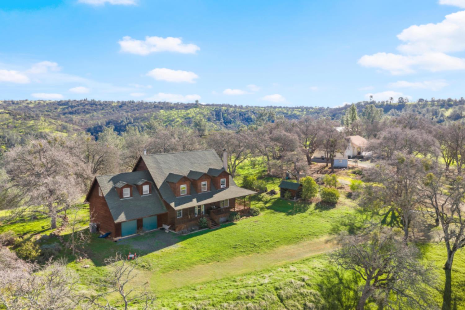 8251 Buffalo Ridge Road Ione, CA 95640 - Photo 5 of 75 an aerial view of a house with yard swimming pool and mountains