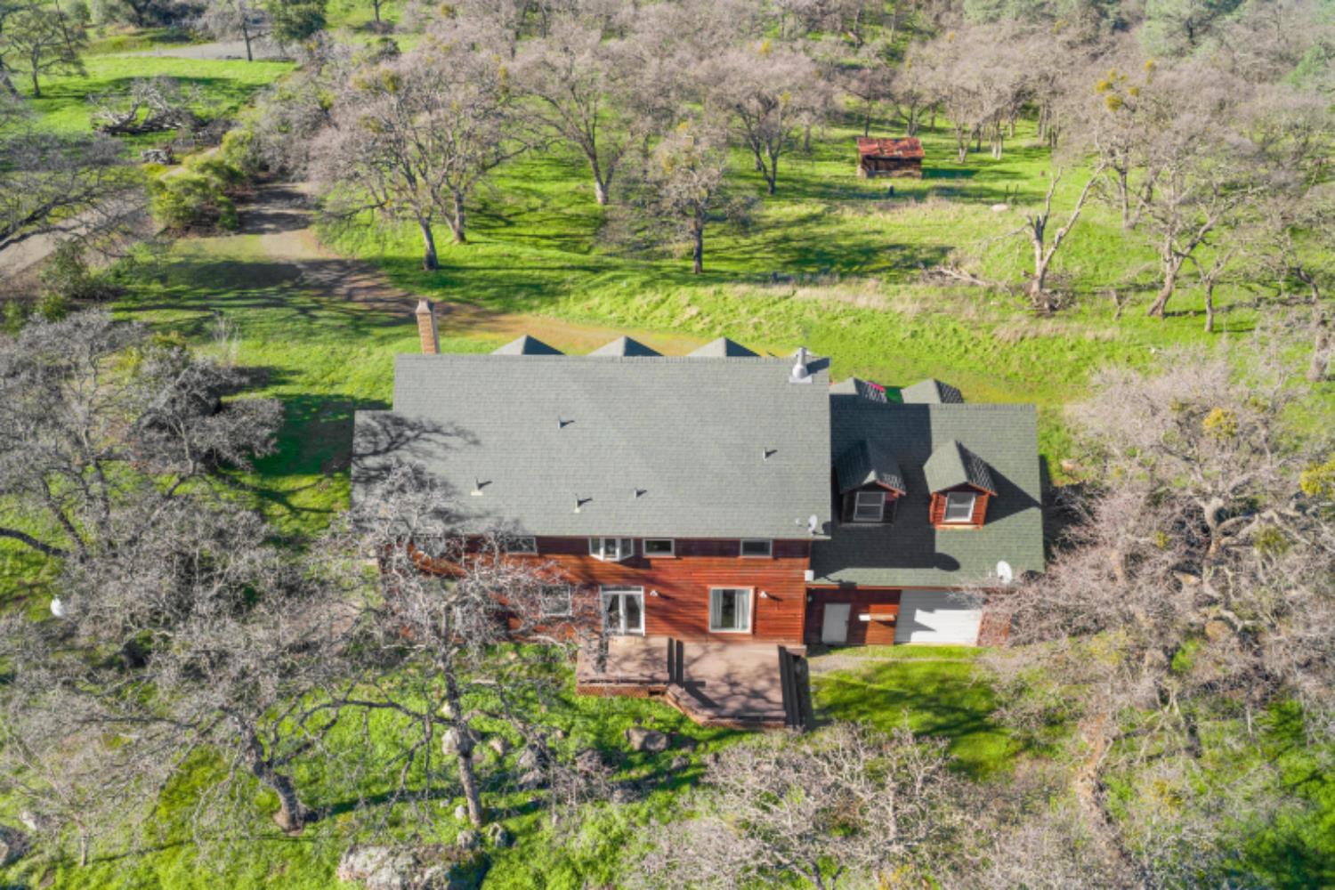 8251 Buffalo Ridge Road Ione, CA 95640 - Photo 7 of 75 an aerial view of a house with a yard and lake view