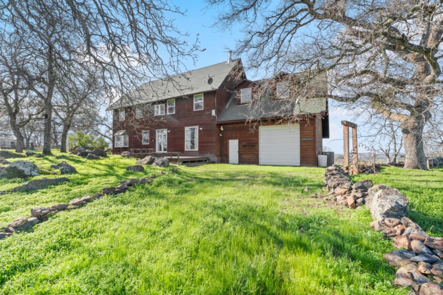 8251 Buffalo Ridge Road Ione, CA 95640 - Photo 71 of 75 a brick house with a big yard plants and large trees