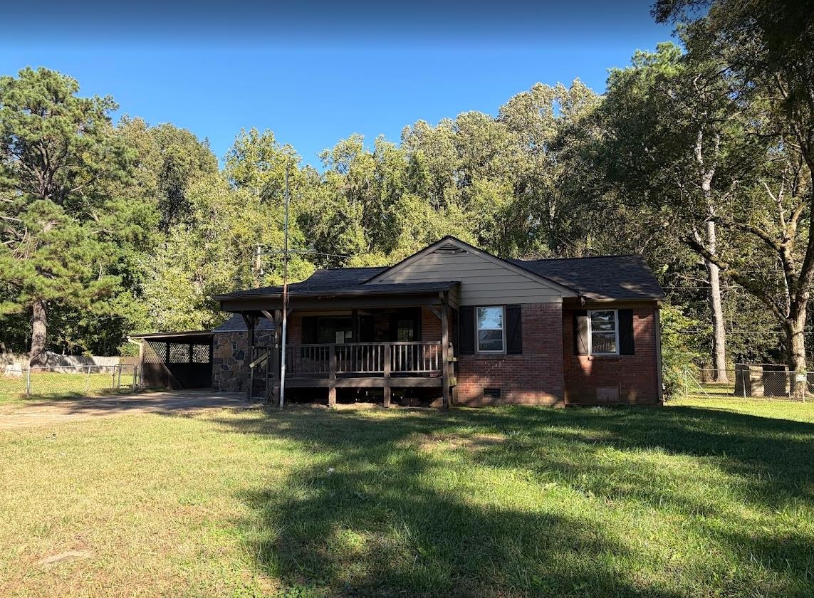 7638 Marvin Road Millington, TN 38053 - Photo 1 of 25 a front view of a house with a yard table and chairs