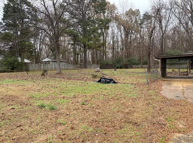 a backyard of a house with trees and outdoor