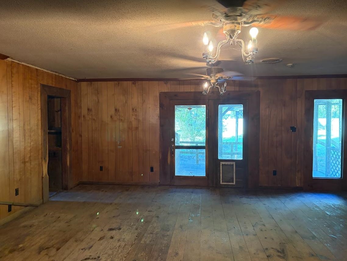7638 Marvin Road Millington, TN 38053 - Photo 7 of 25 an empty room with a chandelier fan and windows