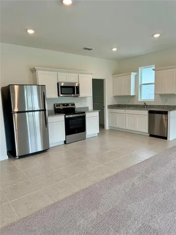 a view of a big house with a yard