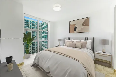 a large white bed in a white room