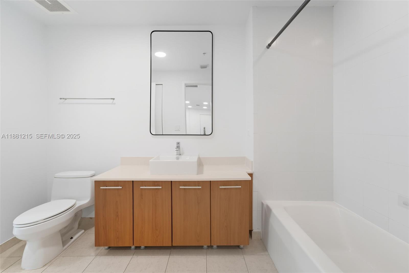 3301 Northeast 1st Avenue, Unit H1510 Miami, FL 33137 - Photo 15 of 23 a bathroom with a toilet a sink a mirror and bathtub