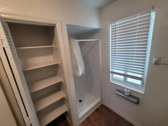 a bathroom with a tub and a window