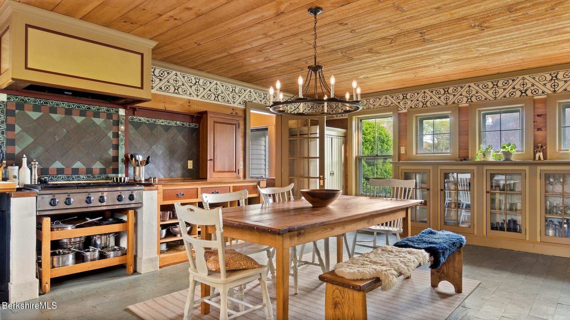 2325 Hancock Road Hancock, MA 01267 - Photo 14 of 61 a view of a dining room with furniture a chandelier and kitchen view