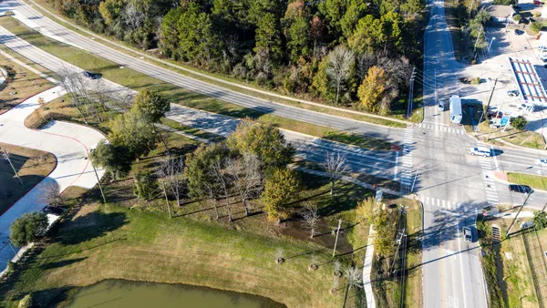 an aerial view of a residential houses with outdoor space