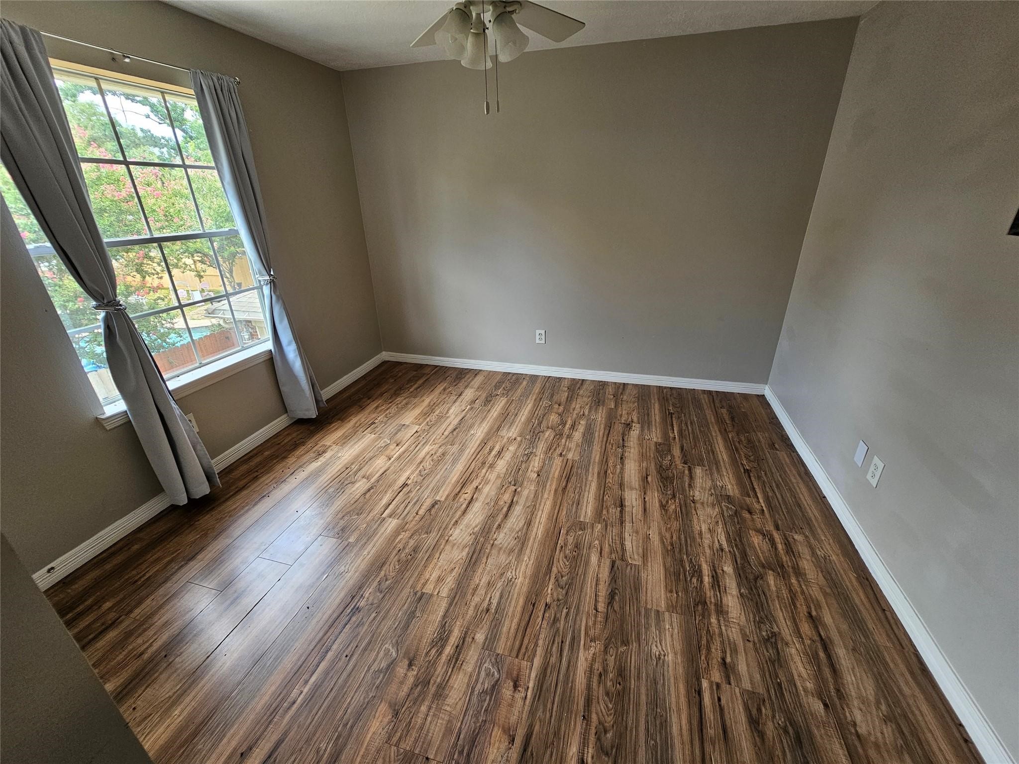 25606 Valley Springs Place Spring, TX 77373 - Photo 18 of 31 wooden floor in an empty room with a window