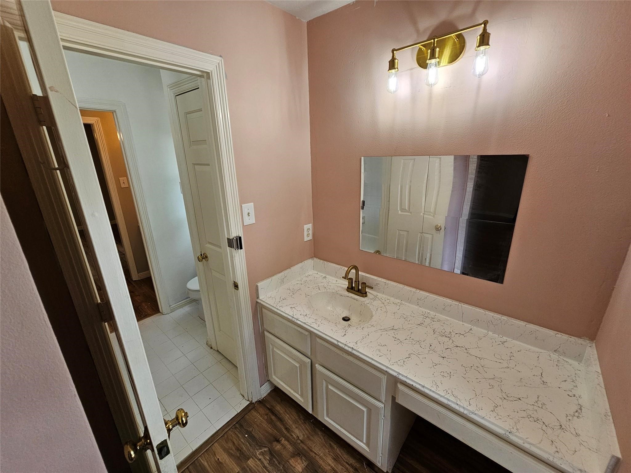 25606 Valley Springs Place Spring, TX 77373 - Photo 22 of 31 a bathroom with a sink and mirror with toilet