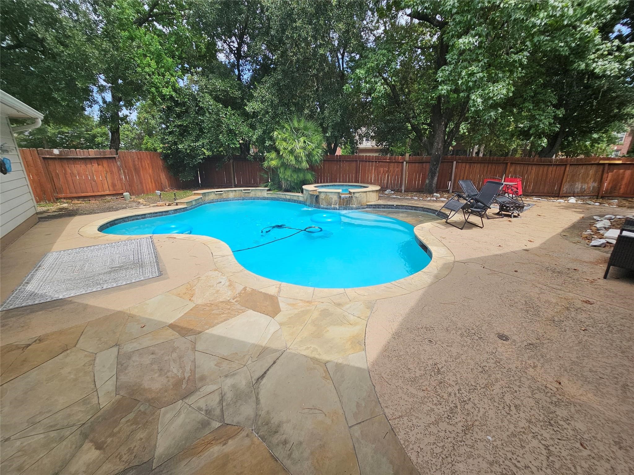 25606 Valley Springs Place Spring, TX 77373 - Photo 26 of 31 a view of a swimming pool with a patio