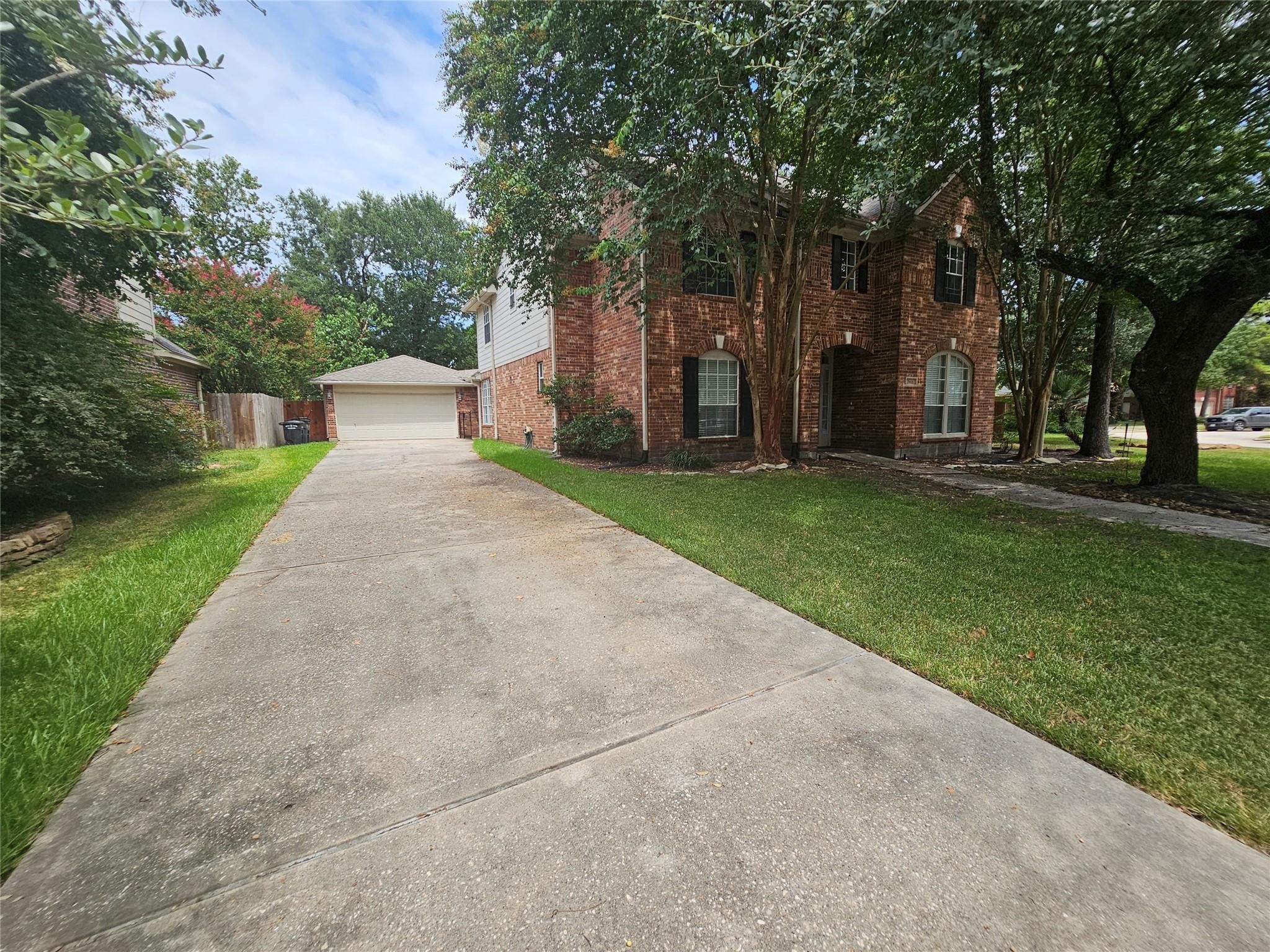 25606 Valley Springs Place Spring, TX 77373 - Photo 31 of 31 front view of a house with a yard and an trees