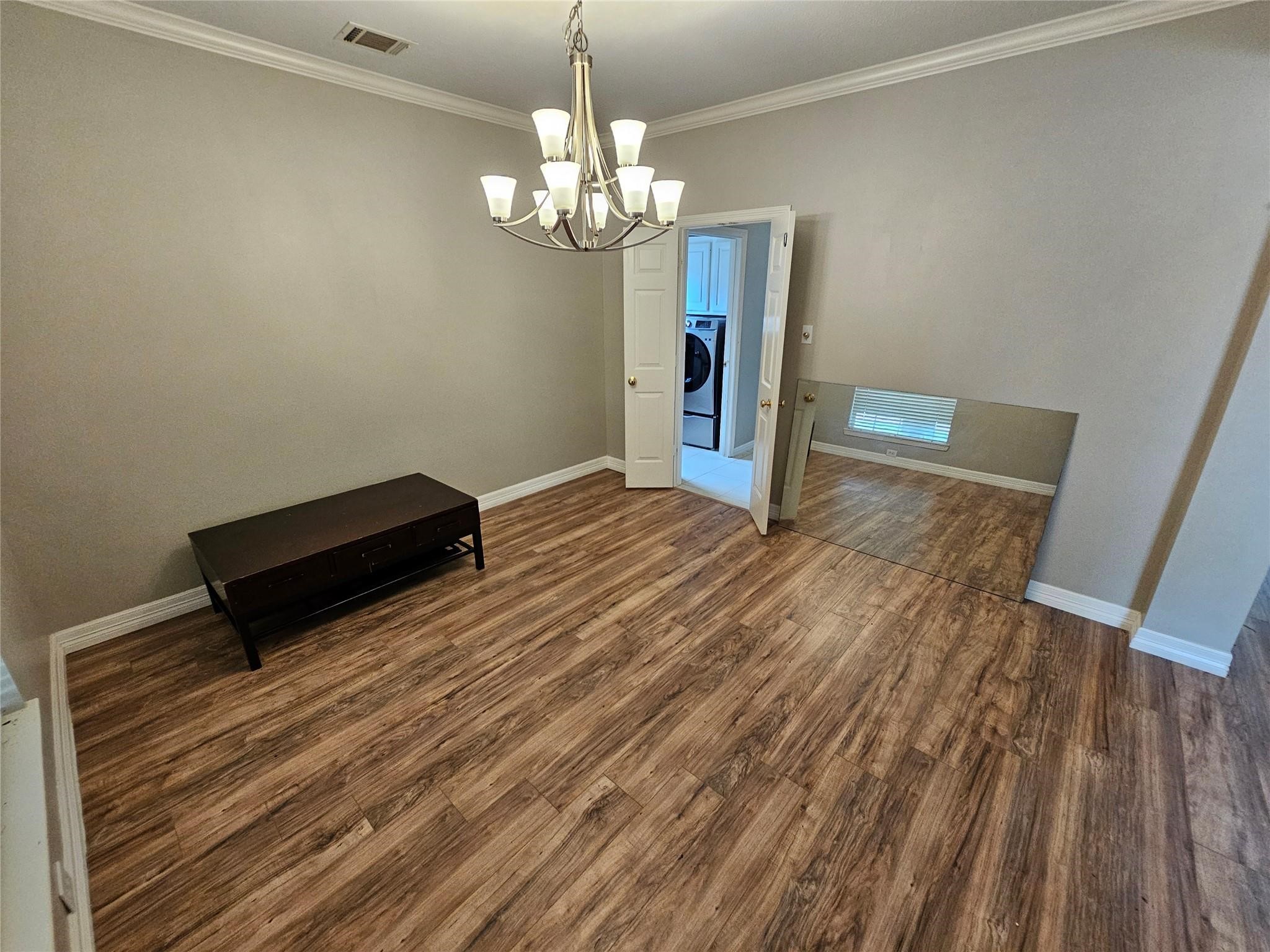 25606 Valley Springs Place Spring, TX 77373 - Photo 4 of 31 a view of a room with wooden floor and chandelier
