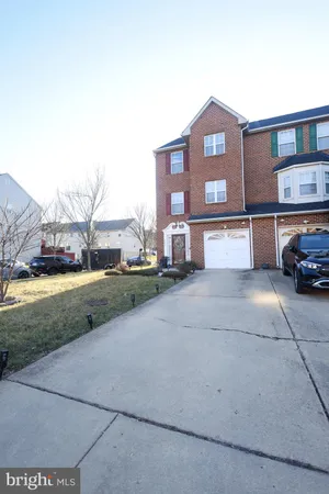 a view of a car parked in front of a brick house