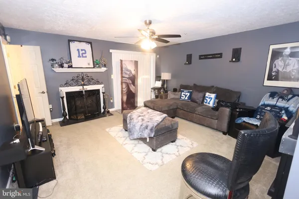 a living room with furniture fireplace and window