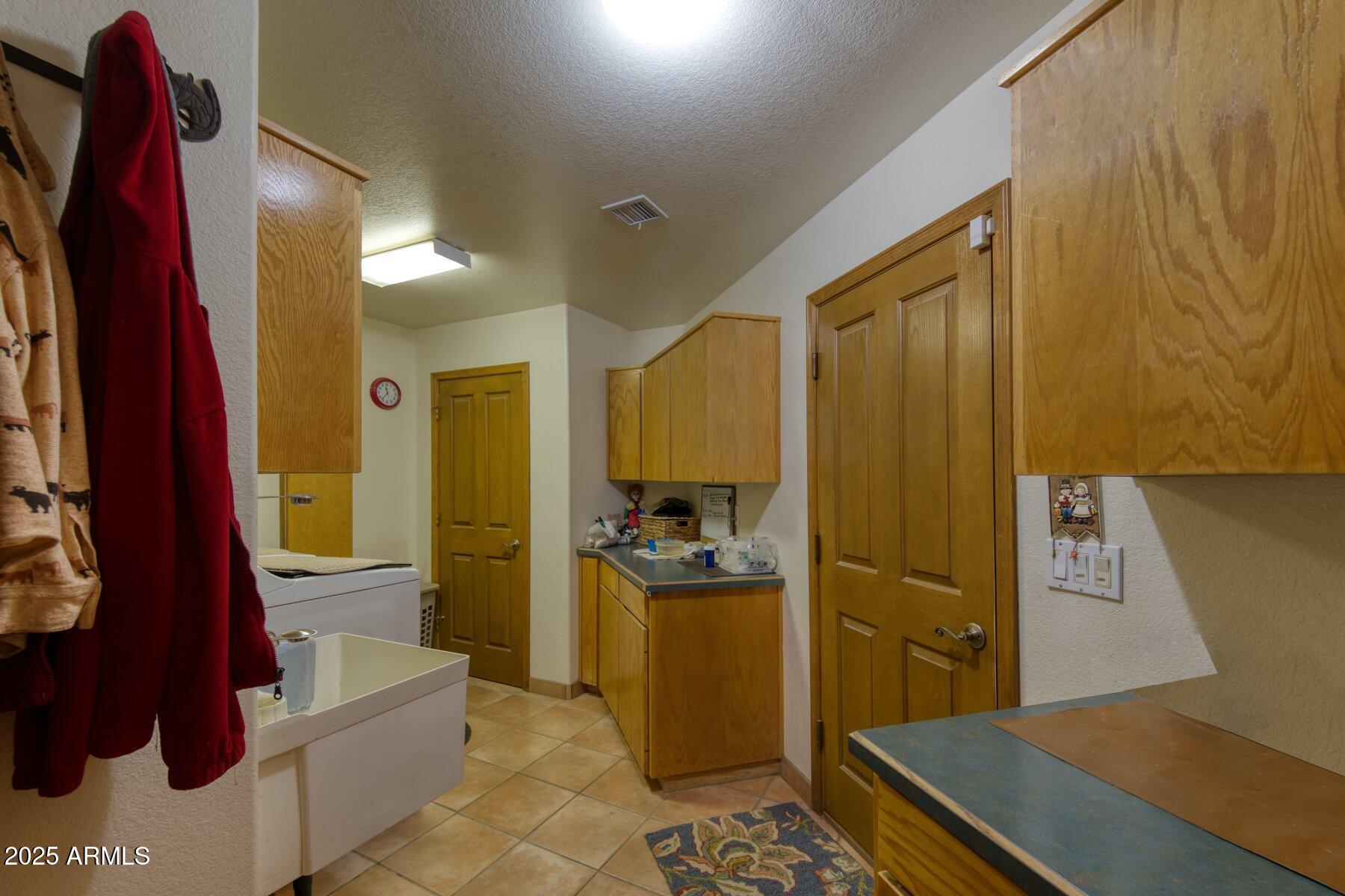 1426 South Foudy Road Bisbee, AZ 85603 - Photo 24 of 60 a kitchen with stainless steel appliances a refrigerator and a stove