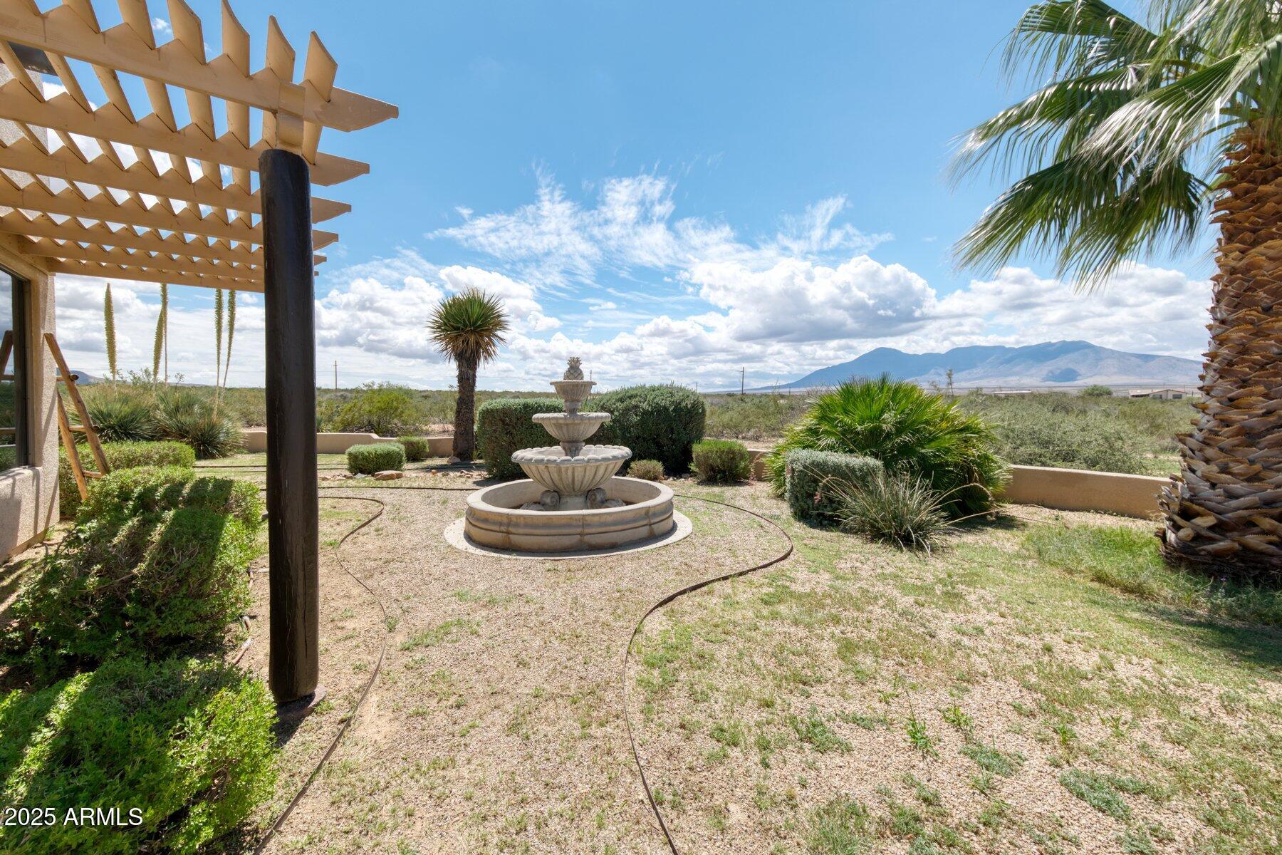 1426 South Foudy Road Bisbee, AZ 85603 - Photo 35 of 60 a view of a backyard with table and chairs potted plants
