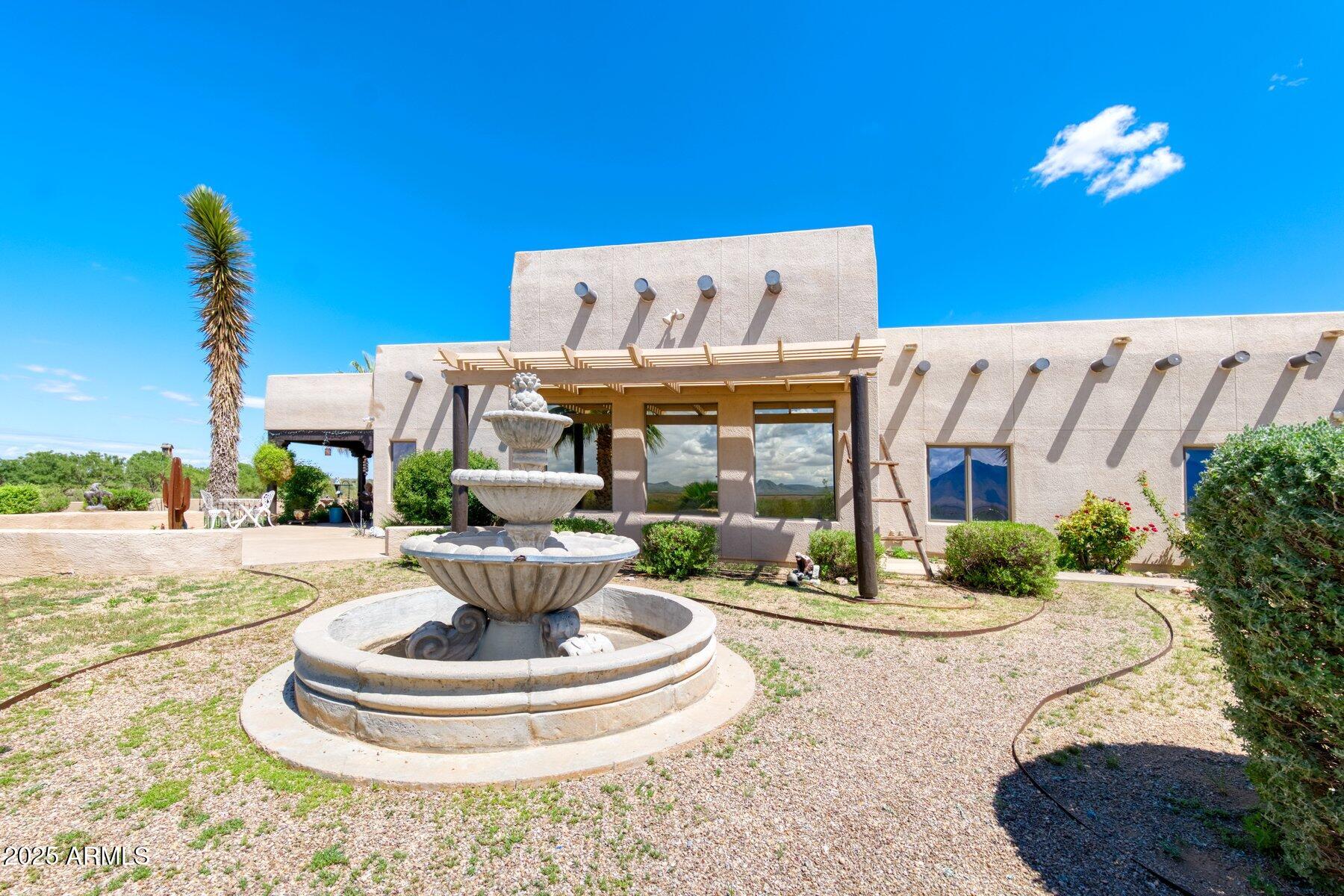 1426 South Foudy Road Bisbee, AZ 85603 - Photo 36 of 60 a view of a lobby with a fireplace and potted plants