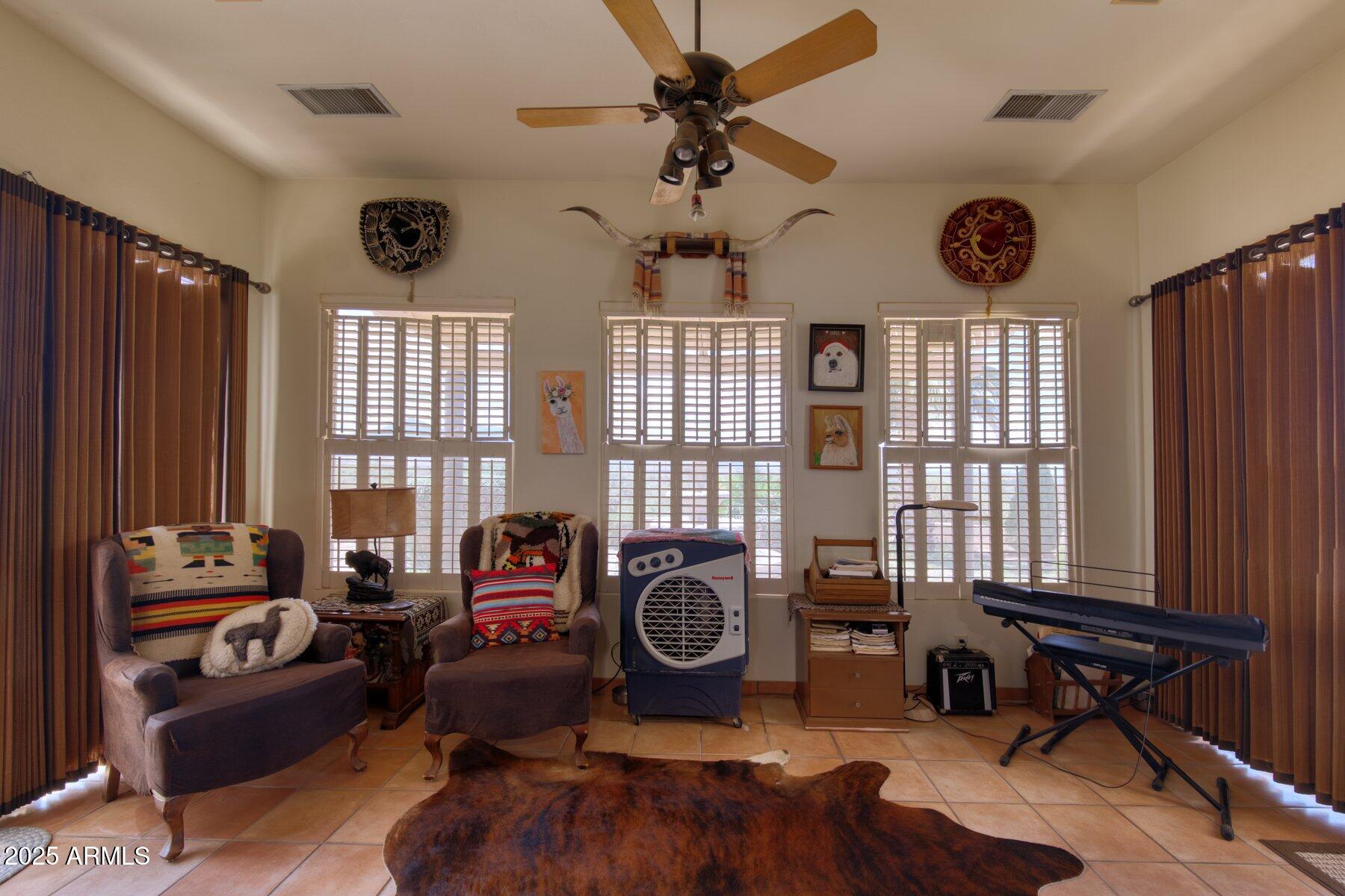 1426 South Foudy Road Bisbee, AZ 85603 - Photo 7 of 60 a living room with furniture a window and a chandelier