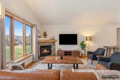 a living room with furniture fireplace and flat screen tv