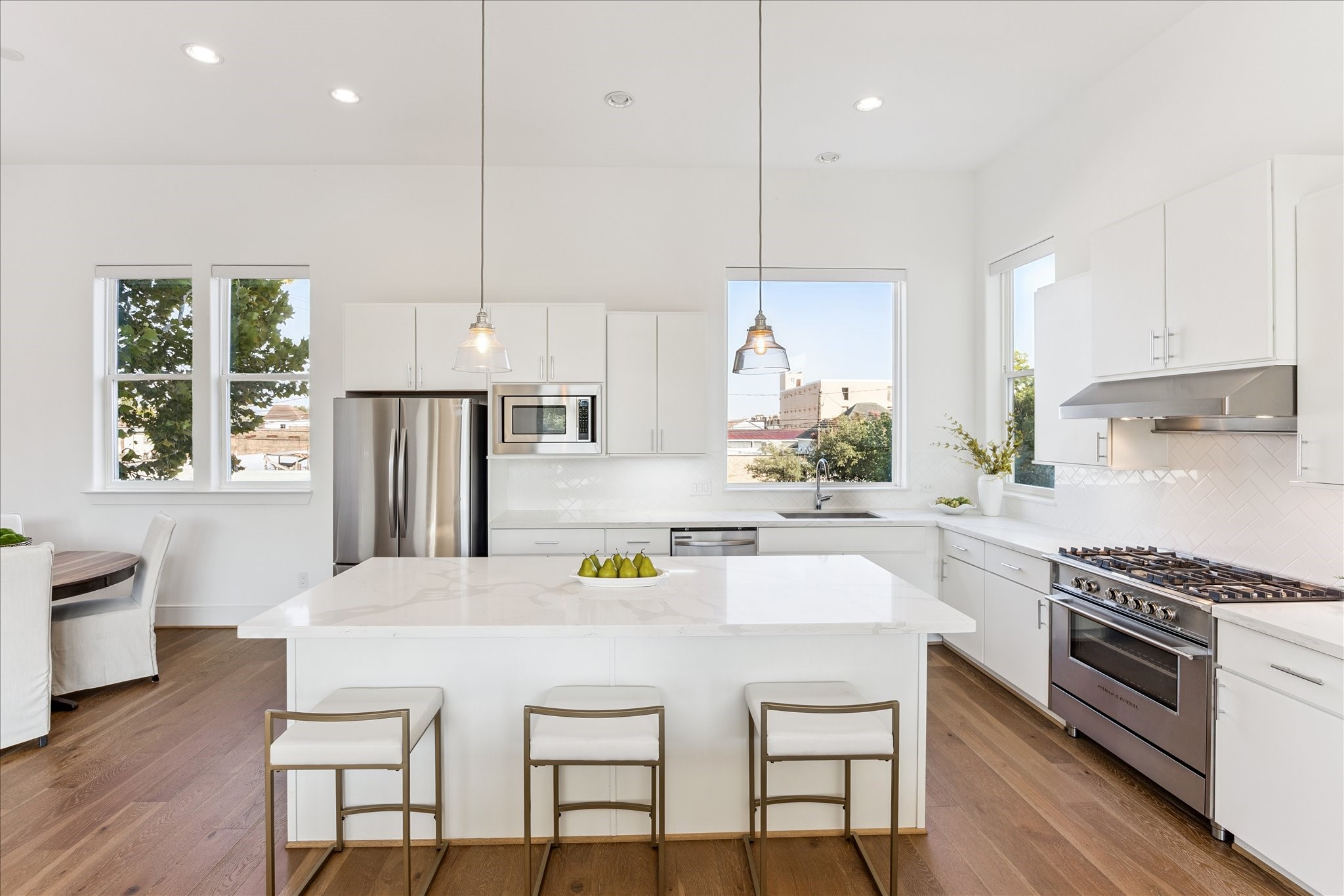 2414 Canal Street, Unit F Houston, TX 77003 - Photo 11 of 34 a kitchen with a table chairs stove and microwave
