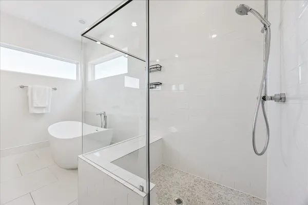 a bathroom with a granite countertop sink a toilet and shower