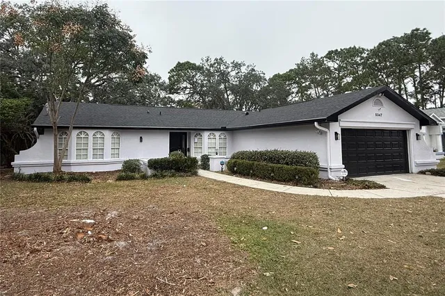 a view of a house with a yard and garage