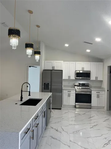 a kitchen with a sink and cabinets