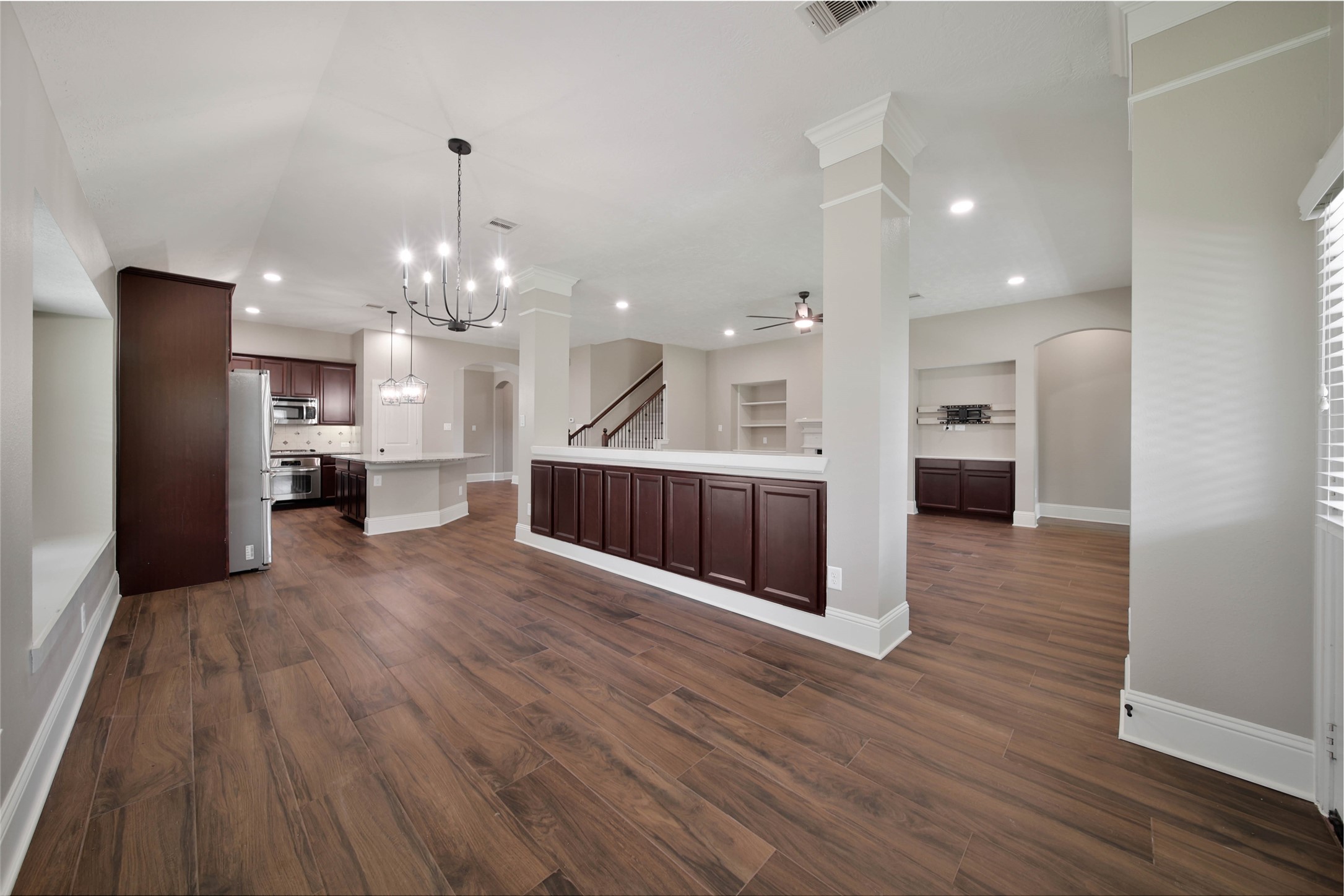 1215 Jake Springs Court Spring, TX 77386 - Photo 11 of 49 A serving bar with cabinetry defines the space while providing loads of storage.