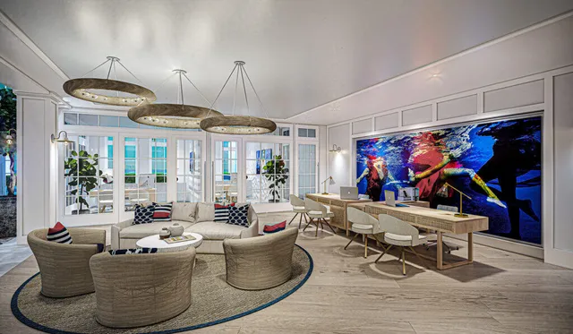 a living room with furniture flat screen tv and outdoor seating