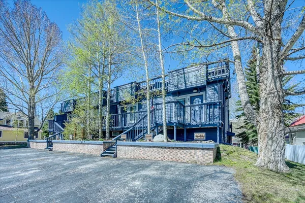 a view of a house with a park and iron fence