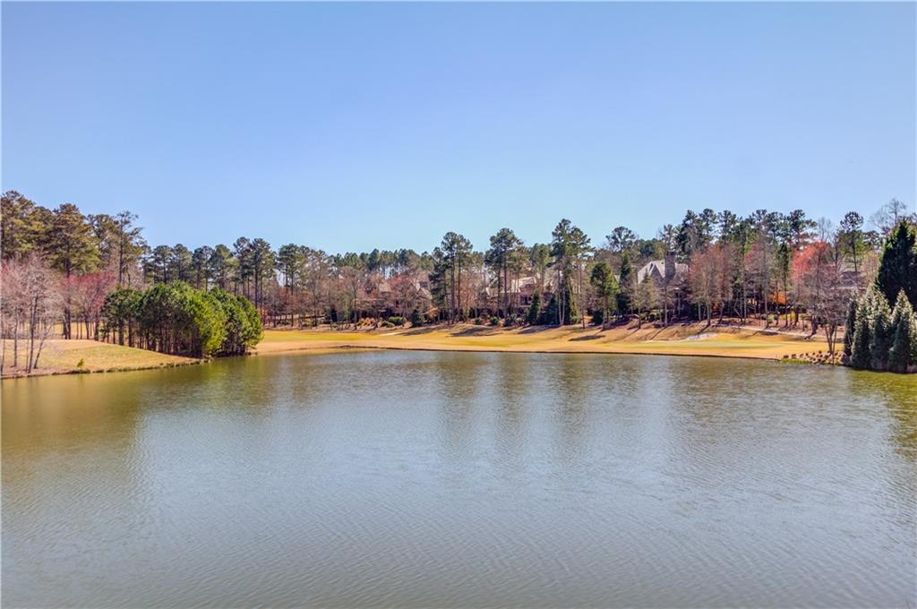 4921 Roaring Fork Pass Suwanee, GA 30024 - Photo 2 of 9 a view of an swimming pool and trees in the back