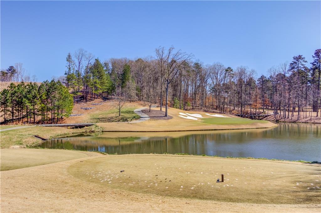 4921 Roaring Fork Pass Suwanee, GA 30024 - Photo 3 of 9 a view of a swimming pool with an outdoor space and seating area