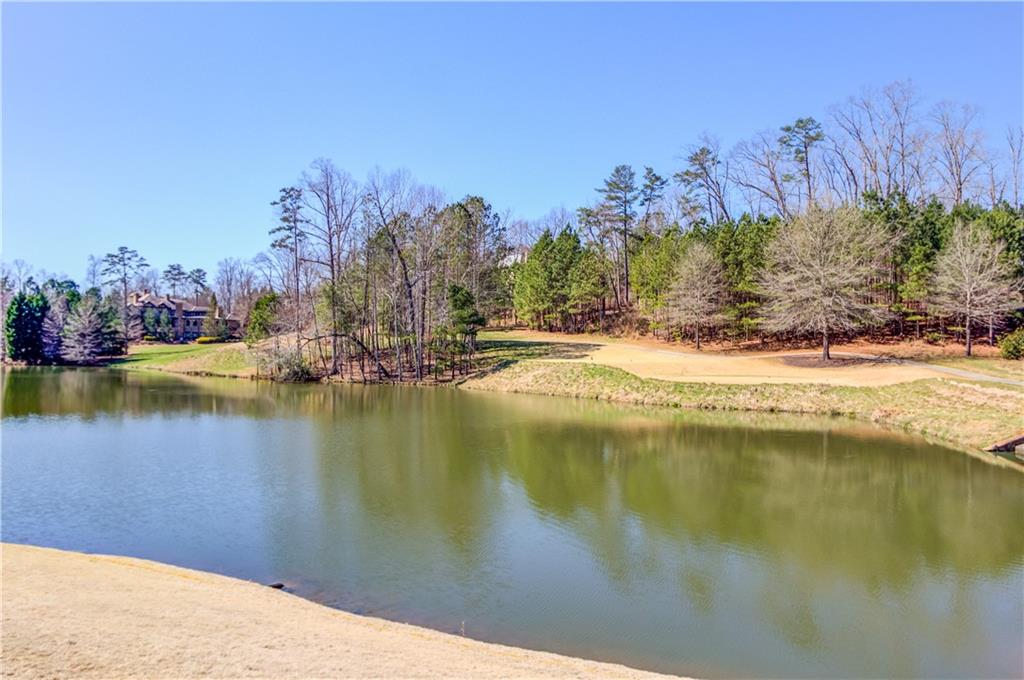 4921 Roaring Fork Pass Suwanee, GA 30024 - Photo 5 of 9 a view of a lake with a mountain in the background