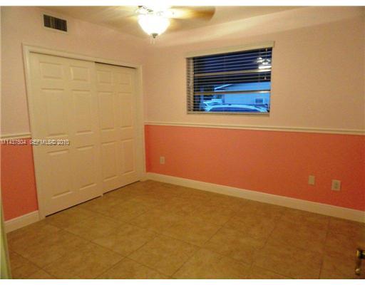 9261 Southwest 88th Terrace Miami, FL 33173 - Photo 11 of 16 an empty room with cabinet
