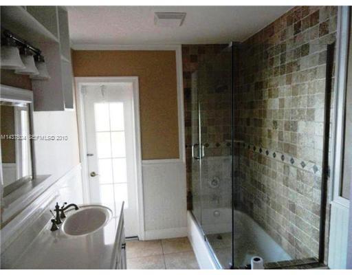 9261 Southwest 88th Terrace Miami, FL 33173 - Photo 12 of 16 a bathroom with a tub and shower
