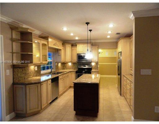 9261 Southwest 88th Terrace Miami, FL 33173 - Photo 3 of 16 a kitchen with stainless steel appliances kitchen island granite countertop a refrigerator and a sink