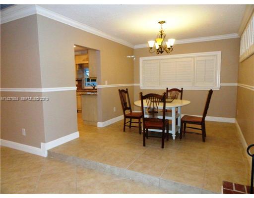 9261 Southwest 88th Terrace Miami, FL 33173 - Photo 5 of 16 a view of a dining room with furniture and chandelier