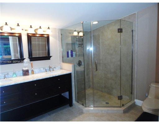 9261 Southwest 88th Terrace Miami, FL 33173 - Photo 8 of 16 a bathroom with a shower sink and mirror