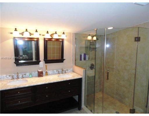 9261 Southwest 88th Terrace Miami, FL 33173 - Photo 9 of 16 a bathroom with a sink vanity and mirror