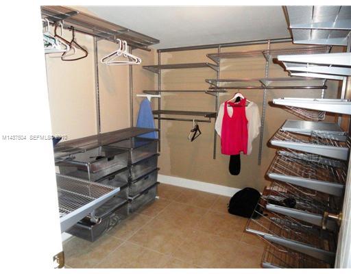 9261 Southwest 88th Terrace Miami, FL 33173 - Photo 10 of 16 a view of walk in closet with clothes and shoes