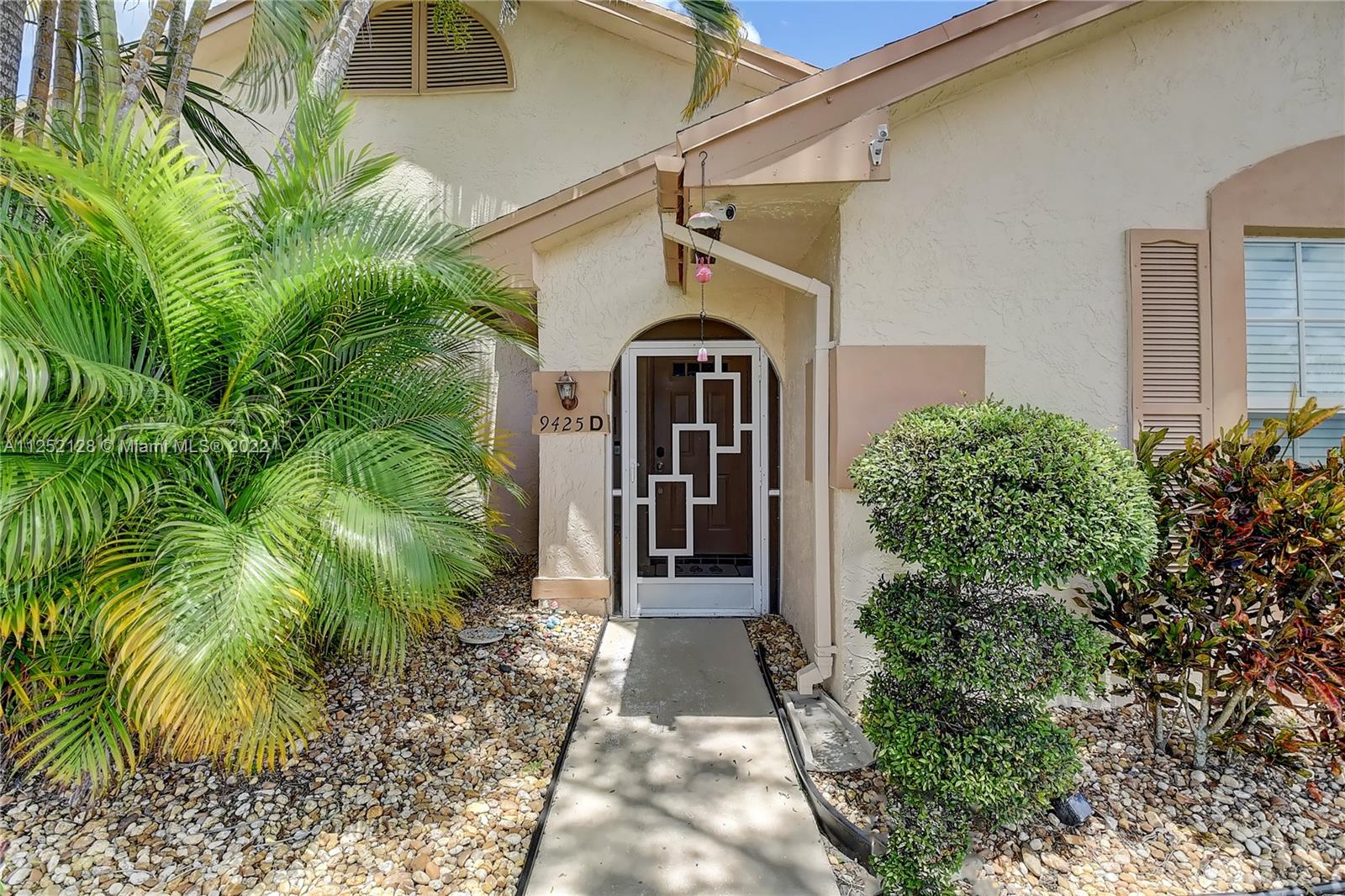 Boca Gardens Boca Raton, FL 33496 - Photo 1 of 19 a view of a house with a small yard plants and large tree